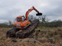 Amphibious digger used to attract wildlife to moor