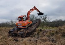 Amphibious digger used to attract wildlife to moor