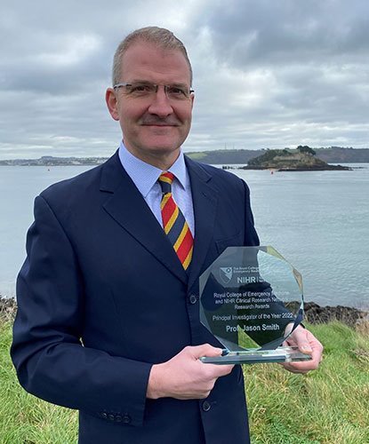 Surgeon Capt Jason Smith with his award 