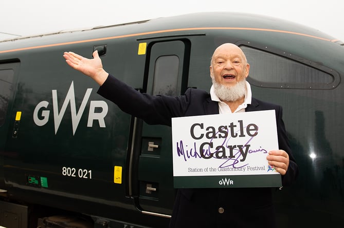 Glastonbury Festival leading light Michael Eavis in front of a GWR high speed train encouraging people to buy their train tickets to the event in advance