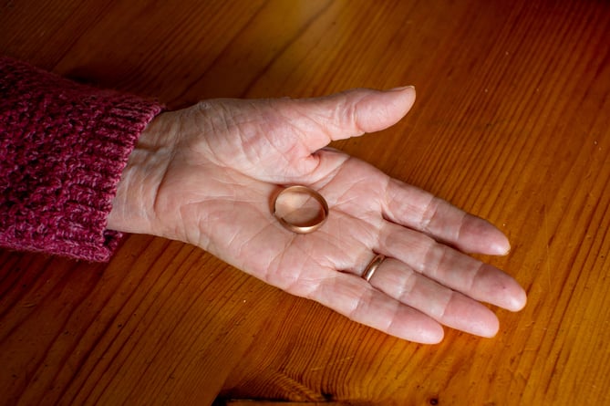 Ann Kendrick from Portlooe, Cornwall, holds her late husband's wedding ring. 27th April 2022  See SWNS story SWPLring. A 90-year-old has found her late husband's wedding ring under an apple tree - 35 years after he lost it in their garden. Ann Kenrick says Peter, who passed away 22 years ago, lost his band while working in their back garden in Looe, Cornwall, in 1987. The mother-of-seven discovered the ring on Saturday (23 April) when she was clearing around the base of an apple tree. She said she was "very excited" to find the ring and added that her husband would have been "as surprised as her".  