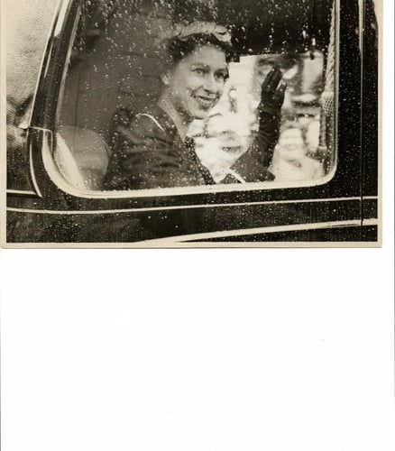 THE Queen waves to the crowd through the window of her car as the cavalcade moves through Liskeard on May 9, 1956