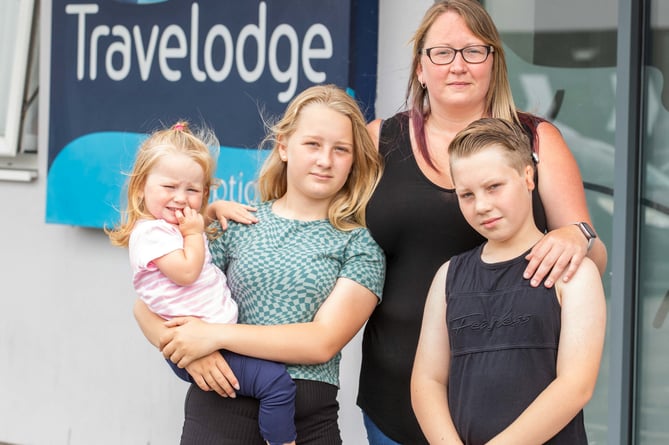 Charlene Pascoe with her children 12-year-old Freya, 10-year-old Kieran and one-year-old Darcy, outside the Travelodge in St Austell, Cornwall. 31st July 2022 . See SWNS story SWLNhotel. A struggling family evicted from their house in Britain's second home capital have been living in a Travelodge for four months - as a council struggle to rehome them. Charlene Pascoe, 34, and her three kids were left with nowhere to go after being evicted from their rental property earlier this year.They have been staying in a hotel room in St Austell in Cornwall for 15 weeks with no idea when they'll be able to leave.Charlene, Freya, 12, Kieran, ten, and Darcy, two, have had to rely on their family and friends who live nearby for meals and play time away from their Travelodge room.