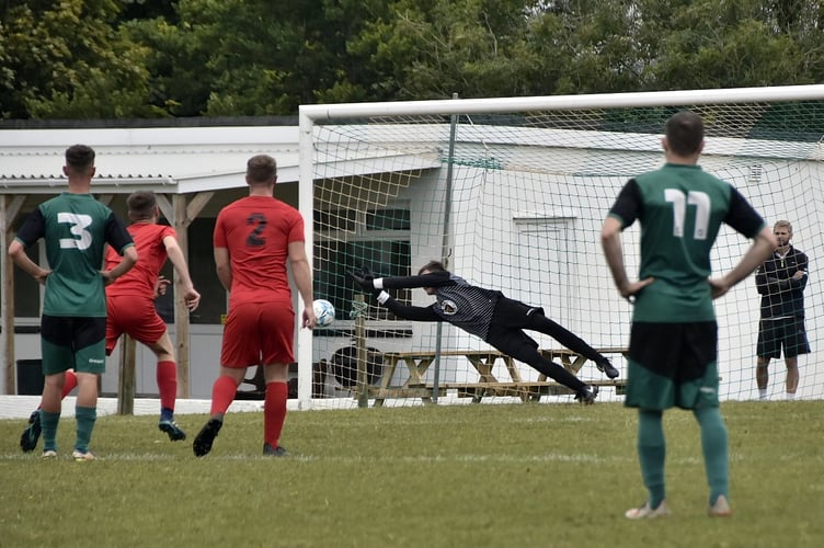 Polperro goalkeeper Cadeyrn Rendle saves a penalty during their 5-0 victory over Callington Town Reserves at Killigarth on Saturday in St Piran League East. Picture: Neil Richardson