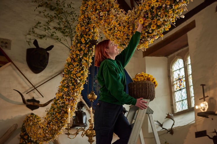 Last few dried flowers being placed in this year's garland Image Credit National Trust 