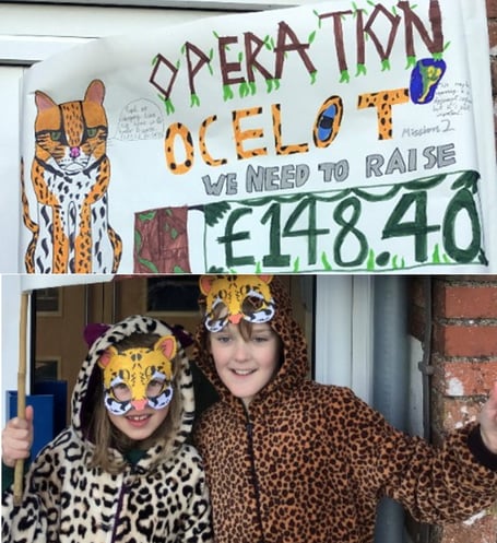 Two pupils in their fancy dress with a cleverly crafted handmade banner