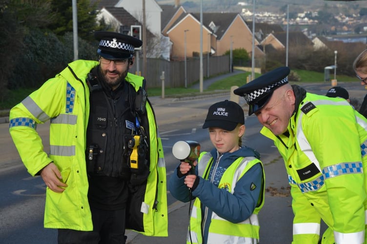 Neighbourhood Beat Manager PC Daniel Ciantar (left) with PC Matt Young on the right. The pupil is Amelie Slade from Year 5 Mantis Shrimp class at East the Water School in Bideford (school is in Mines Road).