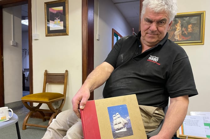 Philip Chatfield, with a book about Sister Assumpta, the ship whose wreck he narrowly survived. 