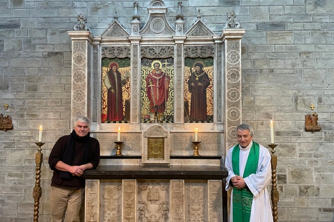 Sculptor and stonemason Philip Chatfield (left), is joined by Father Robbie Low to inspect the new altar. 