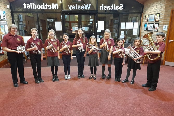 FROM left to right, Saltash Training Band members Jane (MD), Oscar, Marna, Layla, Lamara, Hope, Summer, Megan, Isabella and Henry at the Saltash Music Speech and Drama Festival after winning the David Durham Plate 