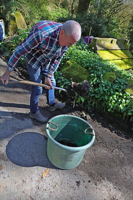 Brian Oldham tidying up the area around the well