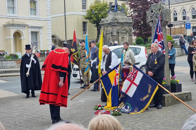 Liskeard mayor Cllr Simon Cassidy is pictured paying his respects during the service
