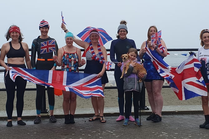 Looe Sea Swimmers put on their royal costumes and braved the choppy sea, to commemorate the coronation of King Charles. The Sea Swimmers then enjoyed cakes and tea after their swim.