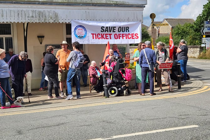 Protestors are pictured outside Liskeard Train Station's ticket office