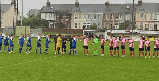 Saltash and Helston players shake hands before the game