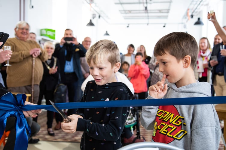 Golden ticket finders PJ and Toby help cut the ribbon to open the new Liskeard Library.