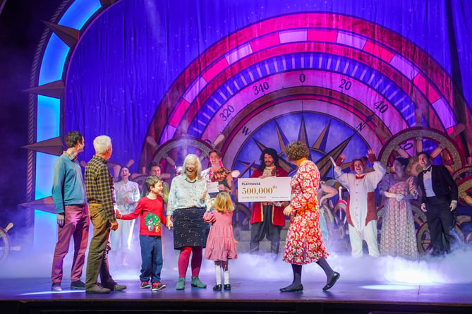 HALL FOR CORNWALL, TRURO, ENGLAND - December 29th 2023 :  The 500,000th member of the public to buy a ticket for a performance at the Cornwall Playhouse, receives their prize from the cast of Peter Pan, on stage, photographed by HfC photographer in residence Hugh Hastings.