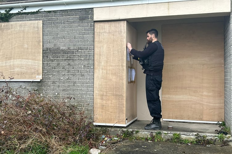Police extending the closure notice on the door