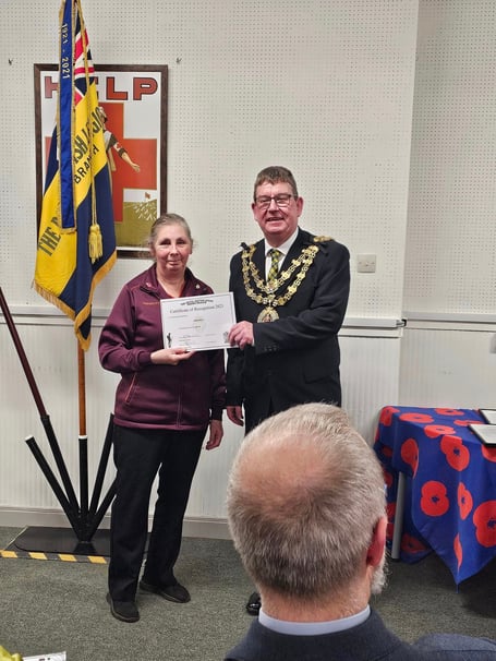 Lynette Smith being presented with a certificate of recognition by the mayor of Bodmin Cllr Phil Cooper