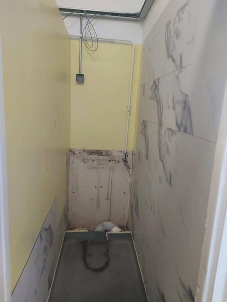 An empty cubicle prior to refurbishment