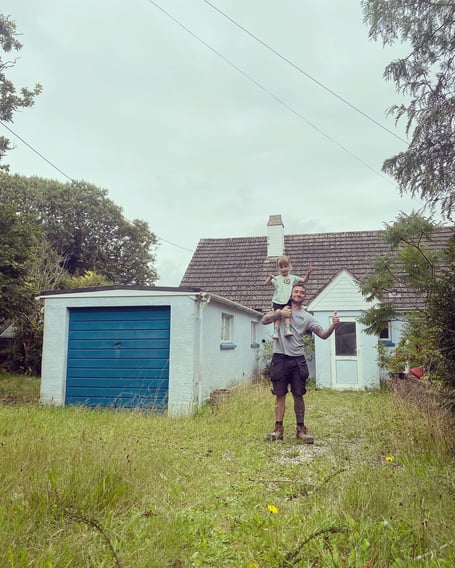Ryan with his daughter Hallie outside their new bungalow in Dobwalls