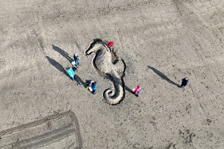 Beach goers who travelled down to Par to take part in the 'Love Your Beach' campaign drew words and pictures in the sand