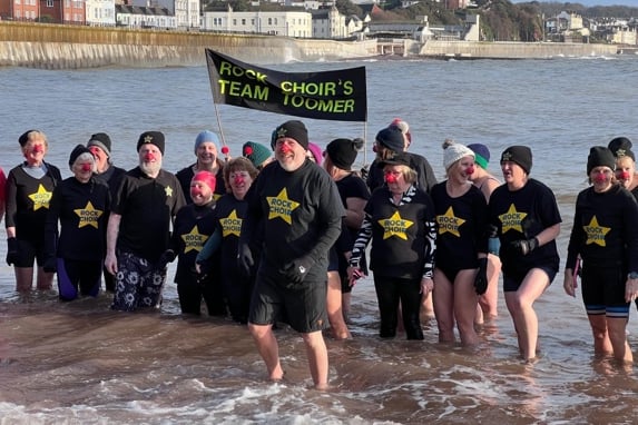 Singers braved the cold to sing in the sea for charity 