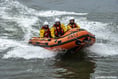 Crew rescue three people cut off by tide