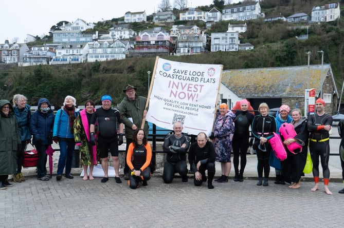 The Looe Sea Swimmers helped to take one of the banners out off East Looe beach 