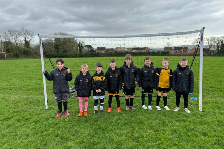 Team Carbeile Under 8s proudly wearing their new jackets