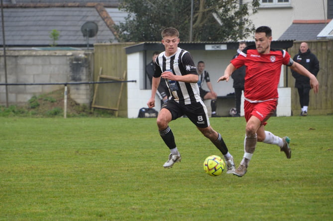 Holsworthy's man of the match Toby Martyn (left) looks to get back at St Austell skipper Neil Slateford. 