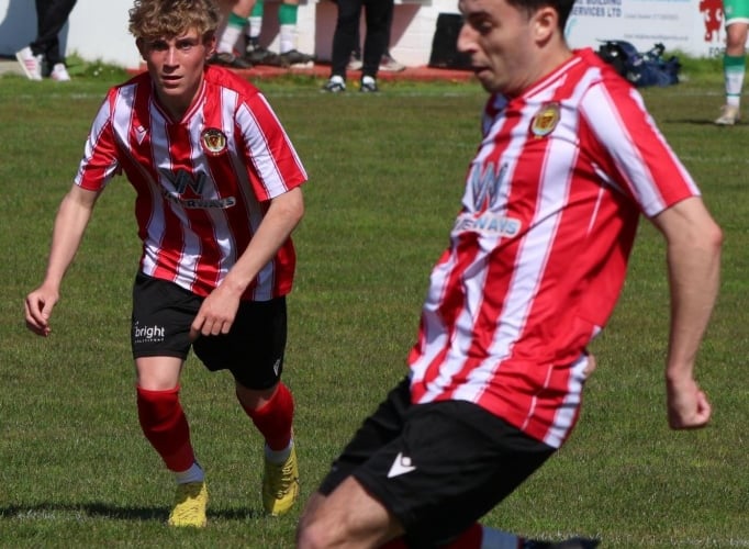 Hat-trick hero Joe Preece slots home a penalty as teenager Jack Jefford, who was making his first Saltash start, watches on.