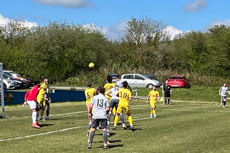 St Dennis' Sam Tattersall rises highest but heads over during Saturday's final day clash with Bodmin Town.