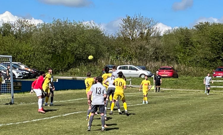St Dennis' Sam Tattersall rises highest but heads over during Saturday's final day clash with Bodmin Town.