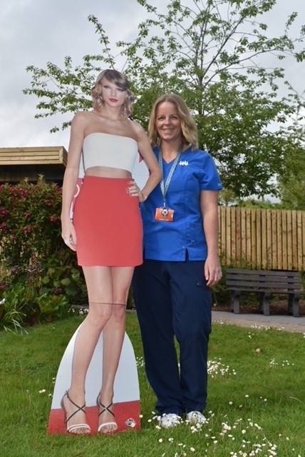 A CHSW nurse with a cardboard cut out of music idol Taylor Swift