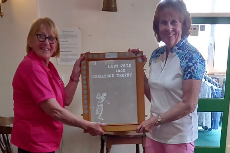 Lady captain Jane Patchett (left) awarding the trophy to lady vets captain, Sara Walker.