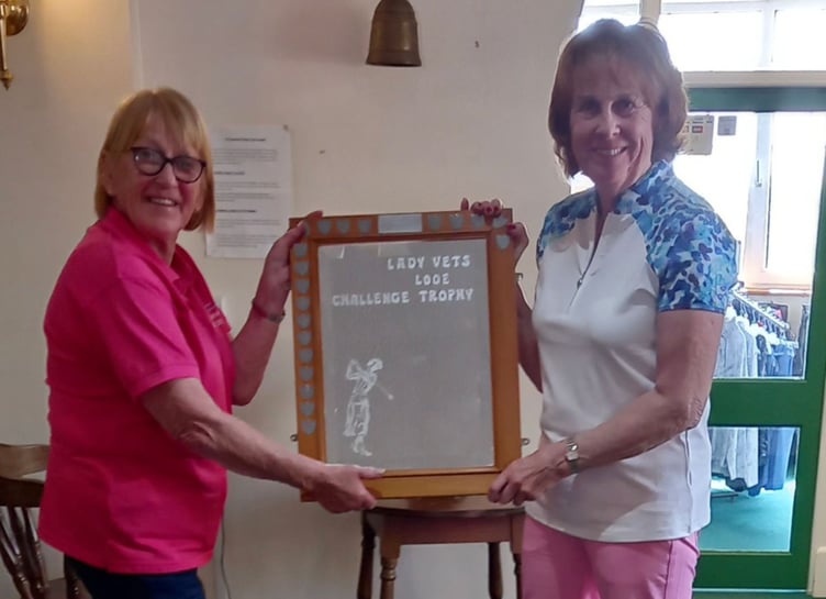 Lady captain Jane Patchett (left) awarding the trophy to lady vets captain, Sara Walker.