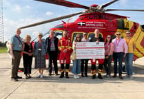 Looe Pioneers hand over cheque to Cornwall Air Ambulance