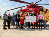 Looe Pioneers hand over cheque to Cornwall Air Ambulance
