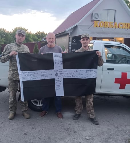 David Pond with two local members of the relief team