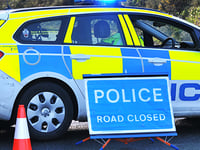 Woman hospitalised after crash between car and van