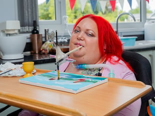 Paralysed woman overcame the odds to paint with her mouth