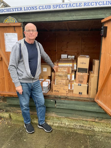 A Lion with the boxes of donated glasses