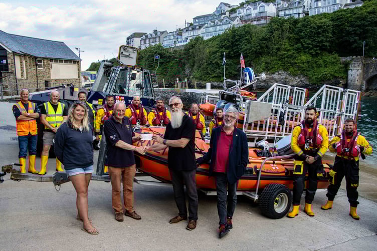 Looe lifeboat operations manager, Dave Haines, accepting the donation from Ivor Campbell with Megan Williams, Jonathan Newman and members of Looe RNLI volunteer crew. (Picture: RNLI/Ian Foster)