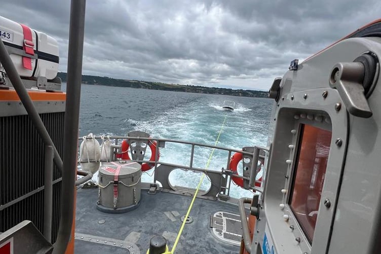 The Fowey all-weather lifeboat rescued three people and a dog, and towed the boat to safety. Picture: Fowey RNLI