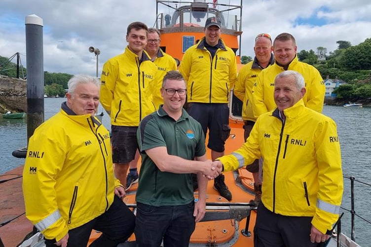 Aiden Libby with coxswain Jonathan Pritchard and other members of the lifeboat crew. Picture: Fowey RNLI
