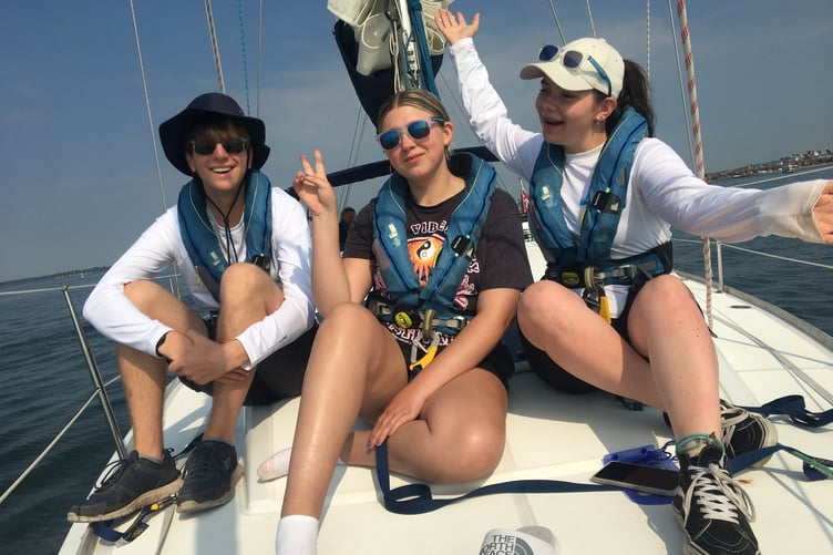 Ellie Kitts, centre, on board an Ellen MacArthur Cancer Trust yacht.