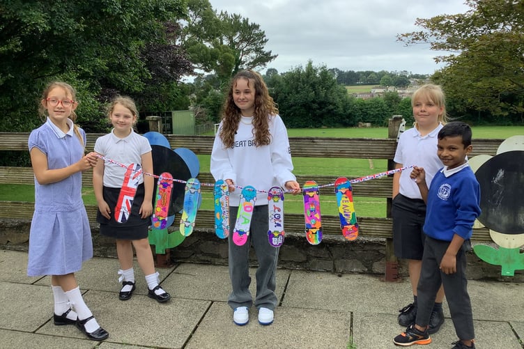 Saltash's Olympic hopeful Lola Tambling with skateboards designed by the children from Brunel Primary Academy