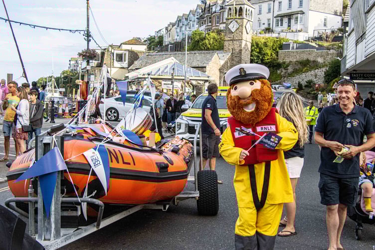 RNLI mascot Stormy Stan waving the flag for the Looe lifeboat team.
