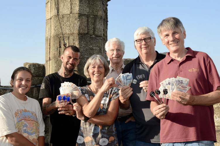 Darts marathon fundraising is passed to Anita Chambers on the Maker Church roof.